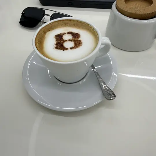 Espresso with foam art — morning workspace detail
